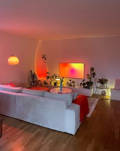 a living room filled with furniture and a flat screen tv mounted to the side of a wall