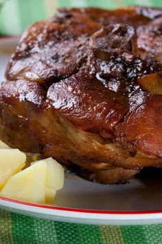 a close up of a plate of food with meat and potatoes