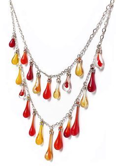 One-of-a-kind necklace, looking for a one-of-a-kind gal - could you be the one?? This necklace is dripping with an eclectic cascade of variegated glass droplets in reds, oranges and yellows. Top tier: 17" sterling silver chain (bottom tier 20") Additional 2.5" sterling silver chain extender, for the perfect position. Sterling silver findings are nickel-free and hypoallergenic Eco-friendly Lightweight and comfortable to wear Handcrafted in USA Sunshine in a drop of glass Each drop of glass is han Waterfall Necklace, Be The One, Recycled Bottles, Chain Extenders, Glass Earrings, Pretty Jewellery, Sterling Silver Chain, Top Tier, Earring Necklace