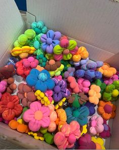 a box filled with lots of colorful fake flowers