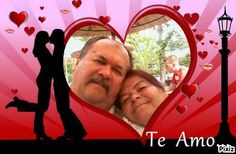 a man and woman standing next to each other in front of a heart shaped frame