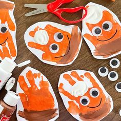 the paper plate is made to look like a handprinted orange fish with googly eyes