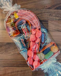 a bag filled with gummy bears on top of a wooden floor