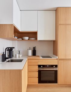 a kitchen with wooden cabinets and white counter tops