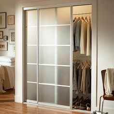 a bedroom with a sliding glass door and pictures on the wall