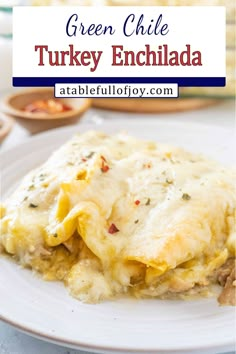 green chile turkey enchilada on a white plate with text overlay that reads green chile turkey enchilada