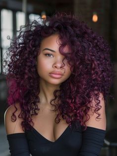 Burgundy, a deep red with a purple tint, is a bold choice that stands out on darker skin. This color is a favorite among curly-haired Latinas, providing a vibrant, eye-catching look that’s perfect for any festive occasion or a bold everyday look. Best suited for round and diamond face shapes, burgundy can make green and brown eyes pop. Fun Colors For Curly Hair, Color Curly Hair Ideas, Black Woman With Purple Hair, Colored Hair For Brown Skin, Color Hair For Brown Skin, Musician Hairstyles, Curly Hair Dark Red, Burgundy And Purple Hair, Brown Hair Colors Curly Hair