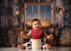 a baby is sitting on the floor and smiling