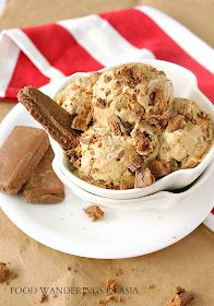 a white bowl filled with ice cream next to two pieces of chocolate and an american flag napkin