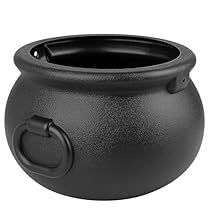 a large black pot with a handle on the side and a hole in the middle