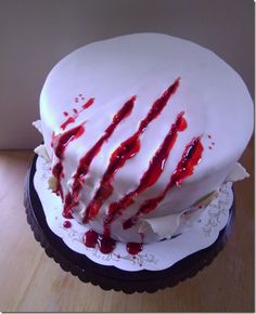 a cake with white frosting and red sprinkles sitting on top of a table