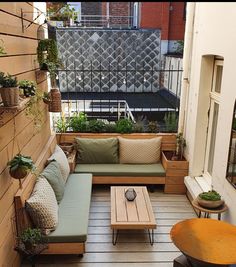 an outdoor living area with couches, tables and potted plants on the balcony