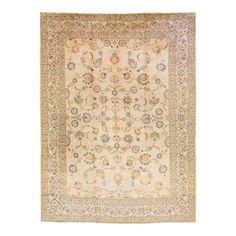 an antique persian rug with floral design on the center and border, all in gold