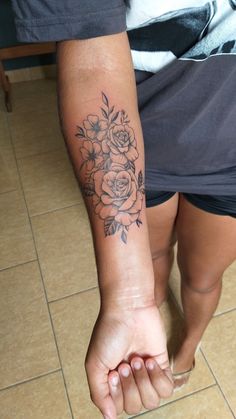 a person with a flower tattoo on their arm