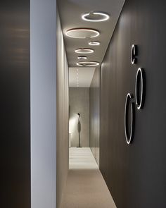 an empty hallway with circular lights on the wall