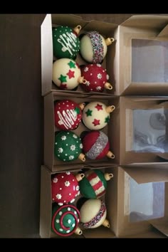 three boxes with ornaments in them sitting on a table