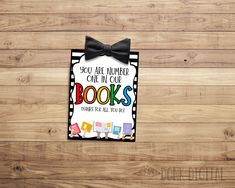 a card with the words you are number one in your books on it and a bow