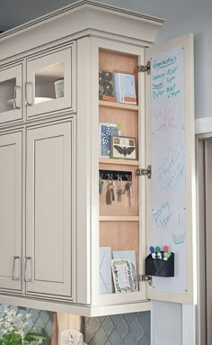 a kitchen cabinet with writing on the door