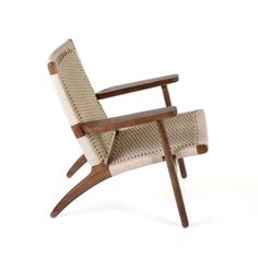 a chair that is made out of wood and wicker with an arm rest on it