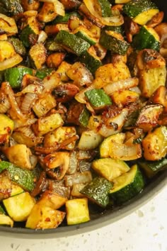 a pan filled with cooked vegetables on top of a counter