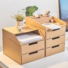 an office desk with two drawers and a keyboard on it, next to a computer monitor