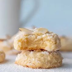 two cookies stacked on top of each other next to a cup