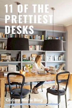 a woman sitting at a wooden table in front of a book shelf filled with books