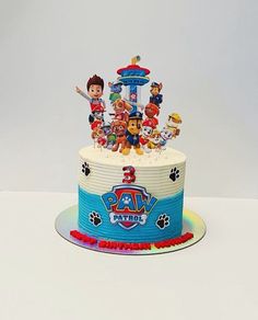 a birthday cake with paw patrol characters on it