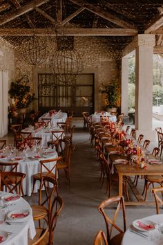 an indoor dining area with tables and chairs set up for formal function or wedding reception