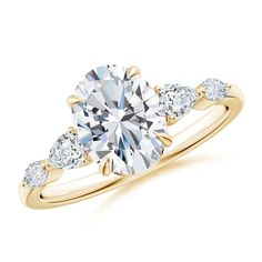 a yellow gold engagement ring with three pear shaped diamonds