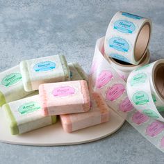 several rolls of toilet paper sitting on top of a plate next to a roll of tape