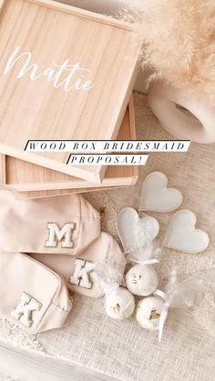 a wooden box filled with white hearts next to other wedding accessories and personalized items