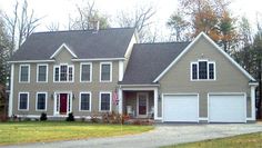 a large house with two garages in front of it