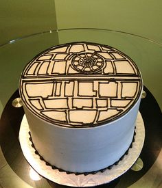 a star wars themed cake on top of a glass table