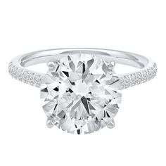 a round cut diamond ring with pave set diamonds on the sides and shoulders, in 18k white gold