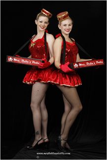 two women dressed in red are posing for the camera