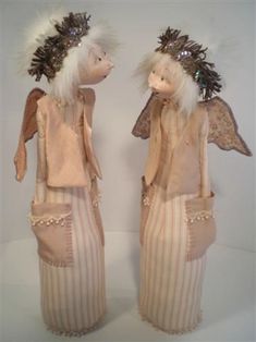 two dolls are standing next to each other