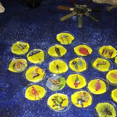 a table topped with lots of yellow plates covered in cartoon characters and spiderman designs