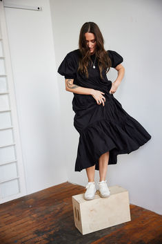 Thoughtfully crafted from ethically-sourced handwoven cotton and defined by its movement-enhancing tiered ruffles, this Short Sleeved Tiered Midi Dress is a timelessly elegant piece that will enliven your wardrobe. Effortless and flouncy, this ruffle dress falls midi length with arm coverage as well. Shop MULXIPLY.COM | Photo by @meredithbrockington1 Fitted Tiered Cotton Ruffle Dress, Chic Dresses With Ruffles And Relaxed Fit, Cotton Ruffle Dress With Tiered Skirt, Tiered Cotton Ruffle Dress, Chic Cotton Tiered Dress With Ruffle Hem, Cotton Tiered Dress With Ruffles, Fitted Cotton Midi Dress With Tiered Skirt, Fitted Cotton Tiered Dress With Ruffle Hem, Relaxed Fit Midi Dress With Ruffles For Daywear