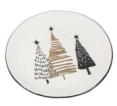 a white plate with black and gold christmas trees on it