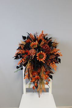 a bouquet of flowers sitting on top of a white chair