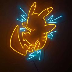 a neon sign that is lit up in the dark with an image of pokemon on it