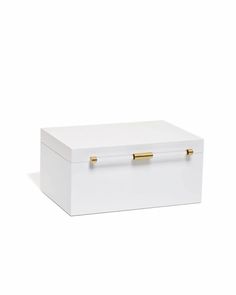 a white box with gold handles on the top and bottom, sitting in front of a white background