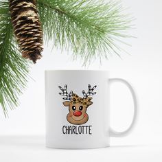 a white coffee mug with a reindeer's head and the words charlotte on it