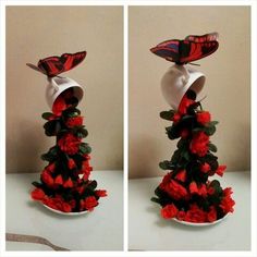 three different views of a red and black hat on top of a flowered tree