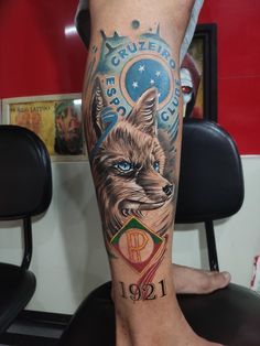 a man with a tattoo on his leg that has an image of a wolf and the number twelve