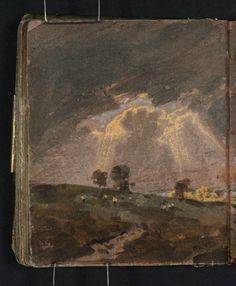 an old book with a painting on the front and back cover that has clouds in the sky