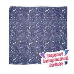 a blue bandanna with stars and crescents on it, in the background is a white