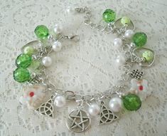 "Pentacle Bracelet This beautiful bracelet has white glass pearl beads, white lampwork glass beads, green faceted beads, silver foil beads, green beads with silver star accents, silver plated bead caps, silver plated chain, pewter silver pentacle and pewter silver charms. 7\" long can be adjusted to 9\". Lobster clasp." Handmade Magical Style Green Jewelry, Handmade Magical Green Jewelry, Symbolic White Beaded Jewelry, Dragons Breath Fire Opal, Wicca Jewelry, Witch Rings, New Plymouth, Wiccan Jewelry, Pagan Jewelry