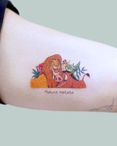 a woman's arm with a lion tattoo on the left side of her body